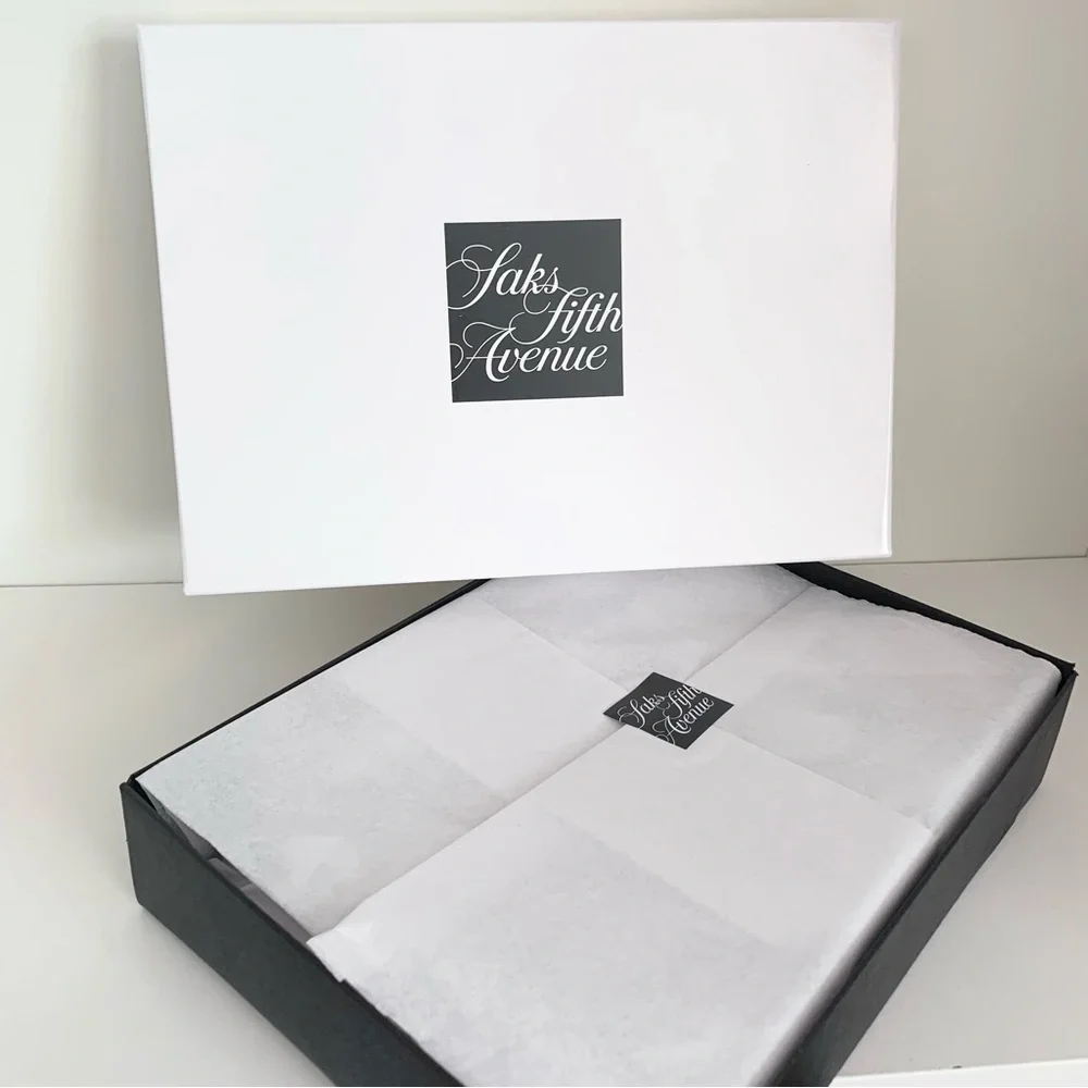 Hold Saks Fifth Avenue gift boxes